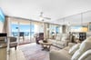 Unwind in your bright oceanfront living room with plush leather seating and stunning sea views stretching endlessly beyond your private balcony.