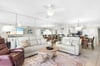 Relax in your spacious openconcept living area, where comfortable seating and coastal decor create the perfect atmosphere for family gatherings and peaceful evenings.