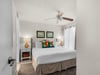 Sink into crisp linens and plush pillows in your private bedroom. A ceiling fan keeps you cool, while warm lamps and coastal artwork create a relaxing retreat after a day of adventure.