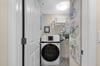 A dedicated laundry room features a fullsize washer and dryer