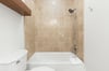 Step into your private bathroom featuring a tubshower combo with elegant beige tile, perfect for unwinding after a day of adventure.