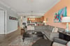 Spacious living area with sectional, enjoy vibrant coastal art, and let the open layout connect you to the fullyequipped kitchen.