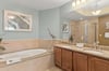 Private spalike bathroom features a soaking tub, walkin shower, dual vanity, and elegant coastal decor. Perfect for relaxing after a day exploring.