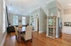 The dining table connects the living room and kitchen.