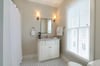 The guest bath has traditional tile floors and a tubshower combo.