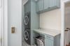 Right off of the primary suite level, guests will find access to a stackable washer and dryer.