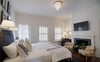 Crisp white linens, and black accents tie this presidential suite together.