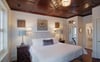 Cherry oak wood ceilings carried through this room, along with crisp white linens and charming decor.