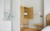 A stacking washer and dryer hide behind the cabinet.