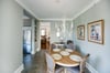 An antique chandelier hangs above the dining room table, and ties the space together.