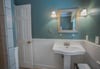 The bead board on the walls gives the bathroom a serene feeling.