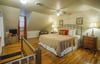 Vaulted ceilings give character to this upstairs bedroom.