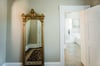 The full length antique mirror accents the space.