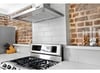 Contemporary subway tile back splash and stainless steal gas stove.