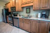 Granite counter tops and stainless steel appliances.