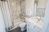 Just off of the hallway, this gorgeous bathroom has been completely renovated top to bottom.