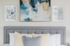 Plush pillows, tufted headboard, and charming decor