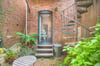 The kitchen door leads to a quaint courtyard space.