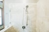 Adjust the shower head to your liking and enjoy this renovated tile shower.