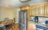 The full kitchen has stainless steel appliances and granite countertops.