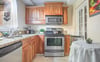 A cafe table provides seating in the kitchen for a quick breakfast.