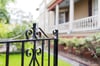 Enter the cottage through the iron gate.