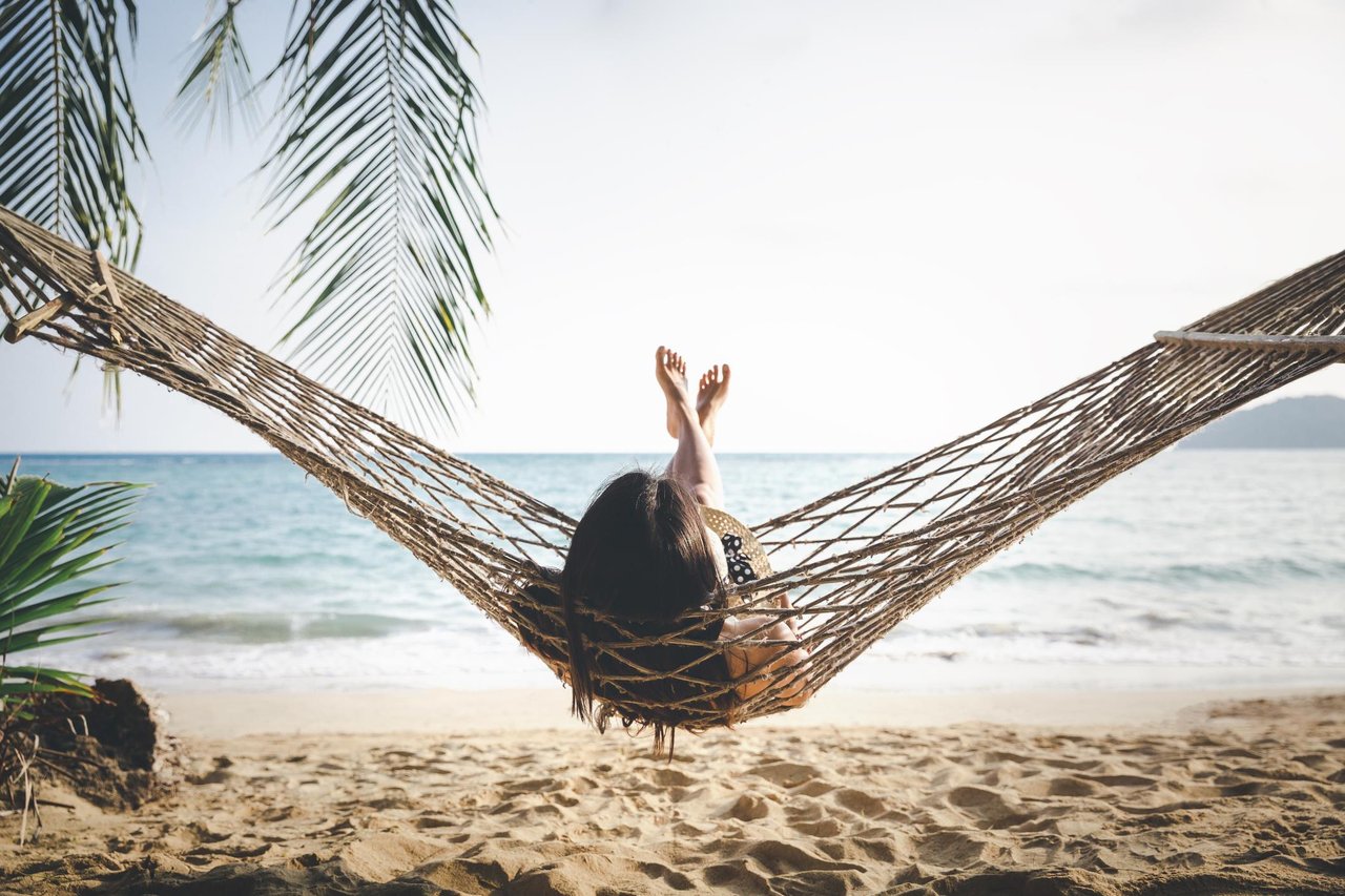 woman relaxing in hammock on beach from Perdido Key vacation rentals