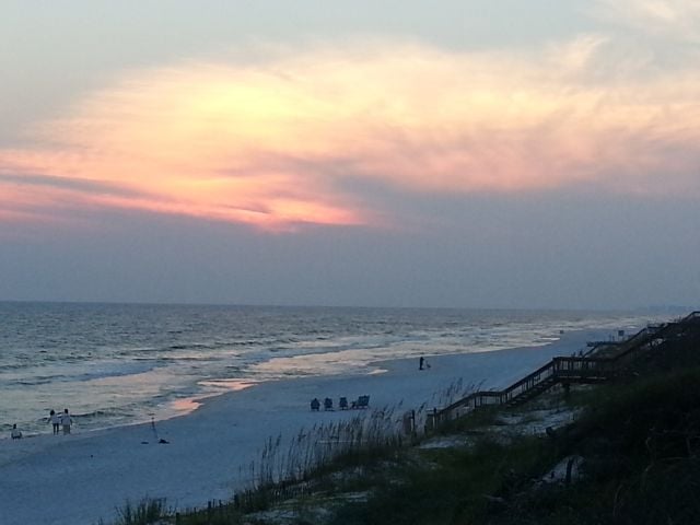 Guests of NewmanDailey enjoy a sunset toast along the beaches of South Walton