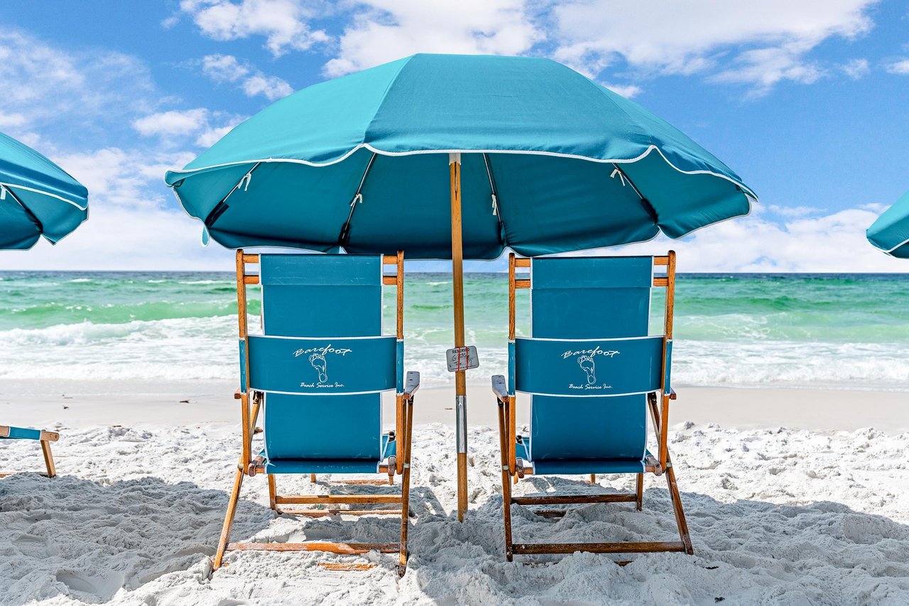 2121169 Chairs Under An Umbrella On A Beach