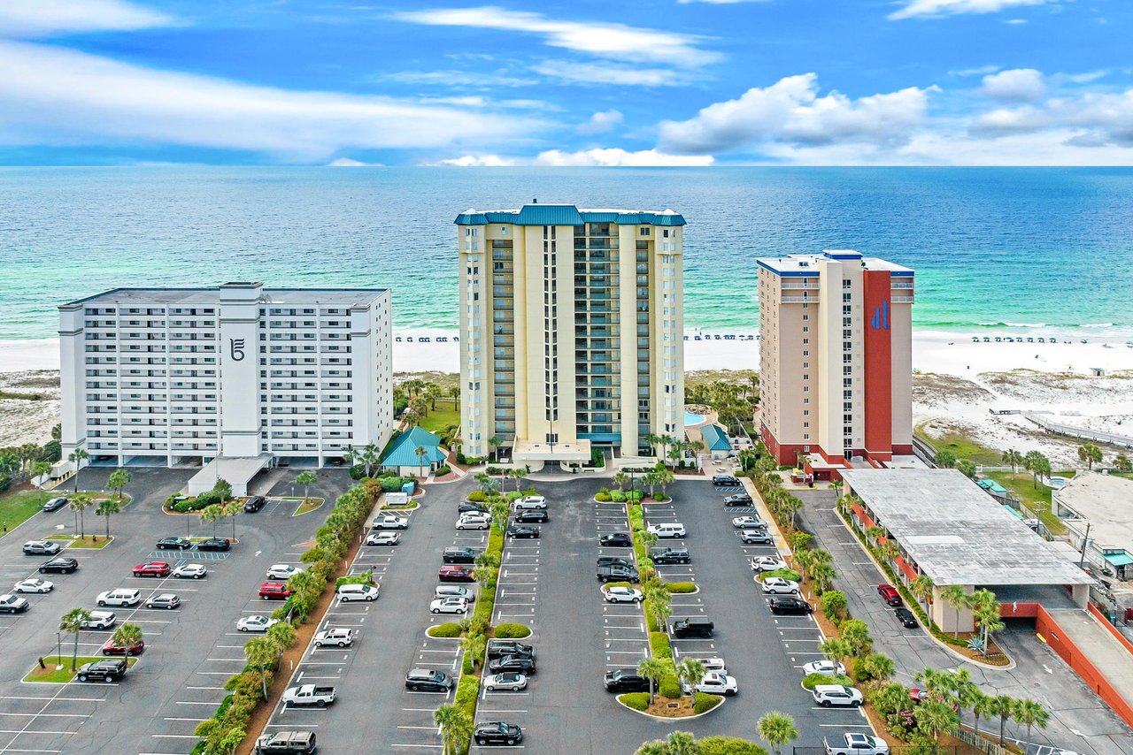 2121173 A Parking Lot With Cars And Buildings By The Water