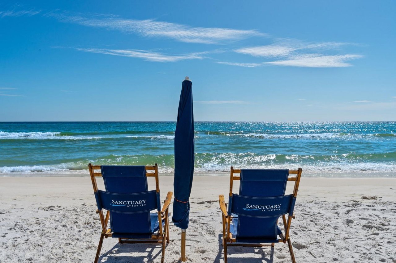 two chairs sit on a beach