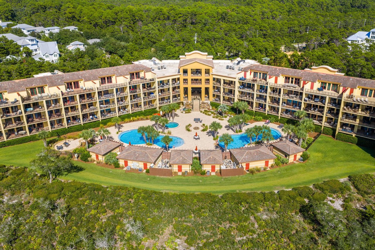 2191154 A Large Building With A Pool In Front Of It