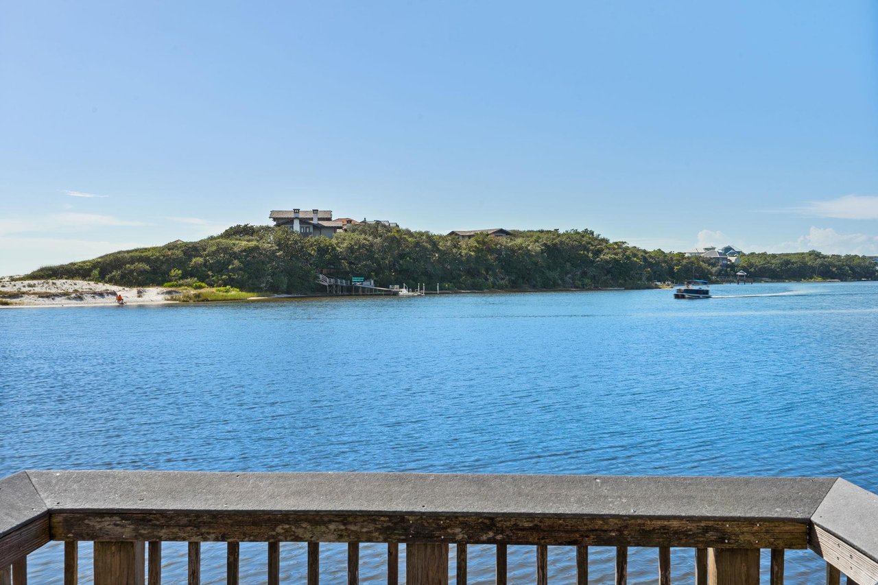 2191165 A Body Of Water With A Boat In It And A Hill In The Background