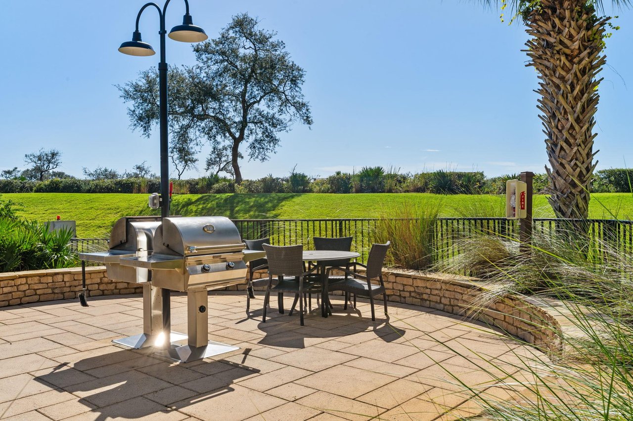 2191184 A Grill And Chairs On A Patio