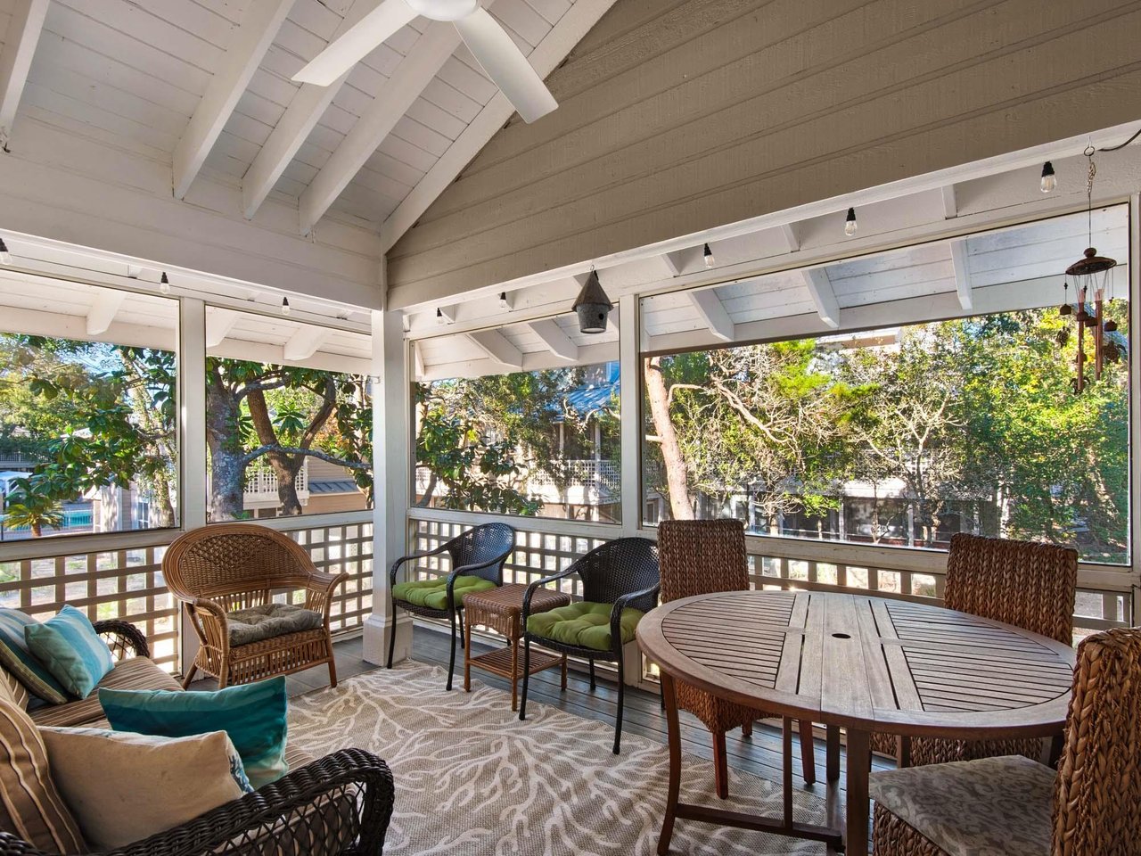 Unwind on your spacious covered patio where wicker seating and a dining table create the perfect outdoor retreat.