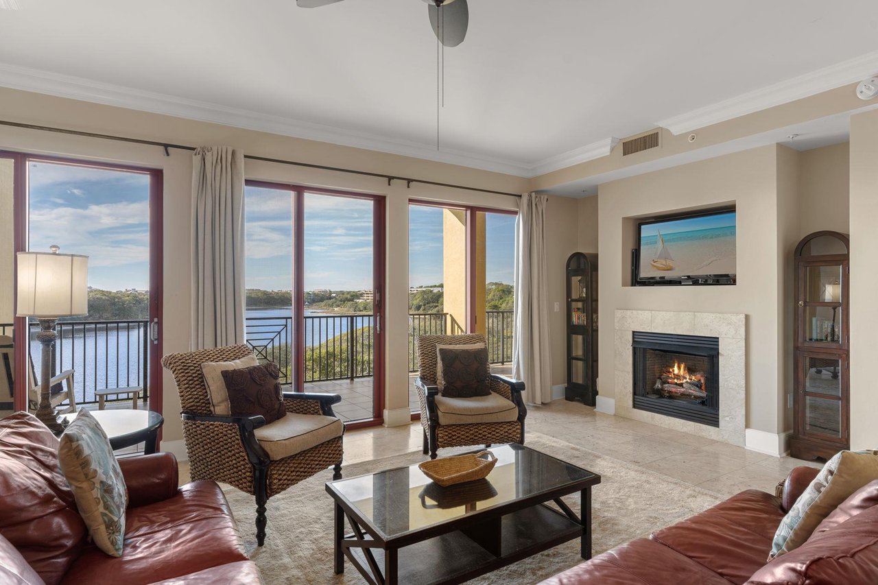Unwind in your elegant living room where gulf and lake views and a cozy fireplace create the perfect backdrop for relaxation.