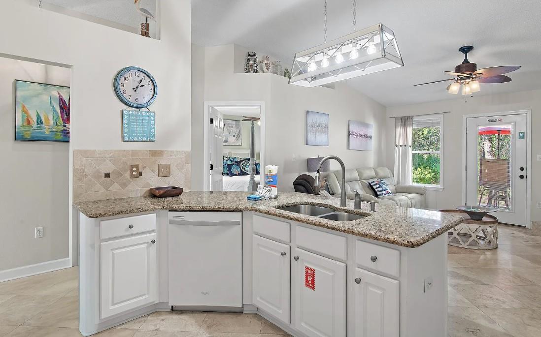 Whip up your morning coffee in this bright, open kitchen featuring granite counters and modern appliances, perfectly connected to your cozy living space.