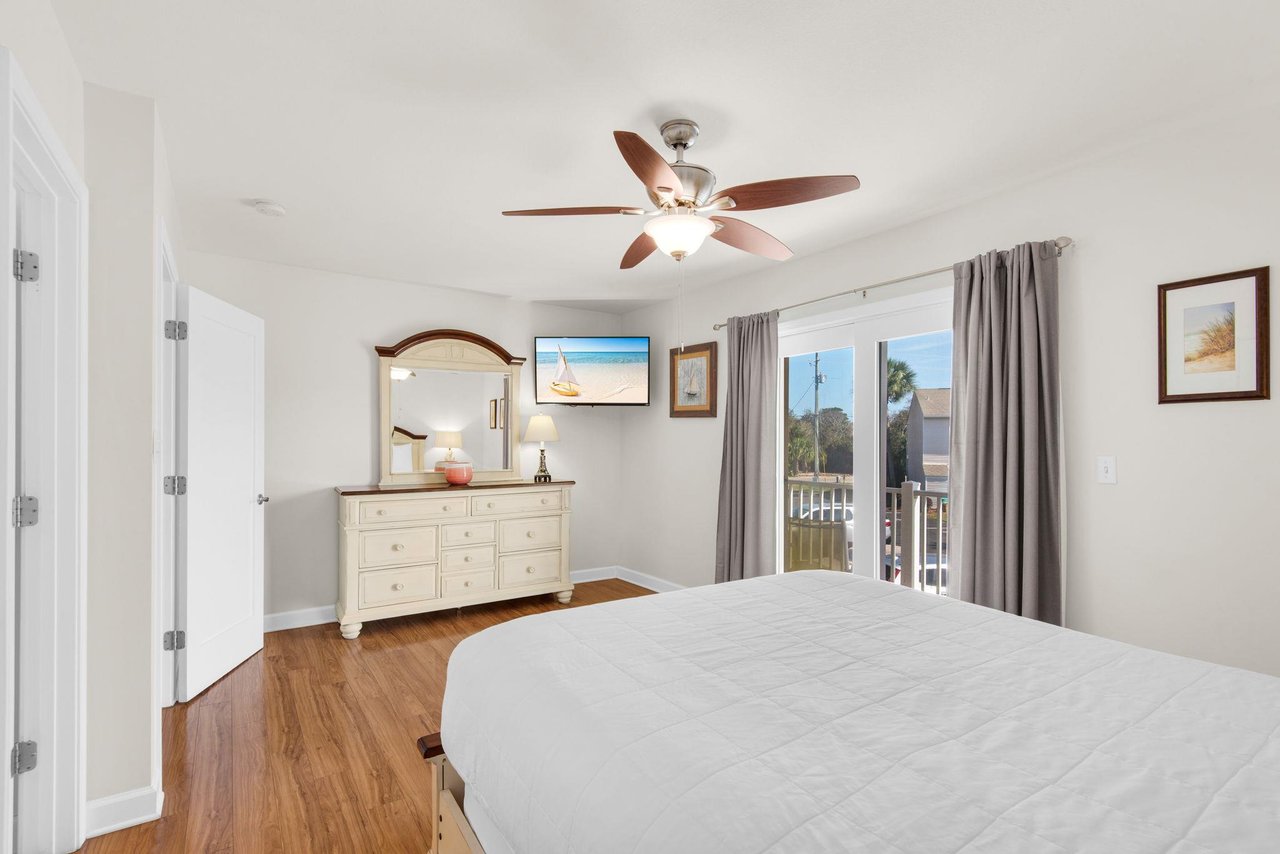 Bedroom 1 features sliders that open to a private balcony