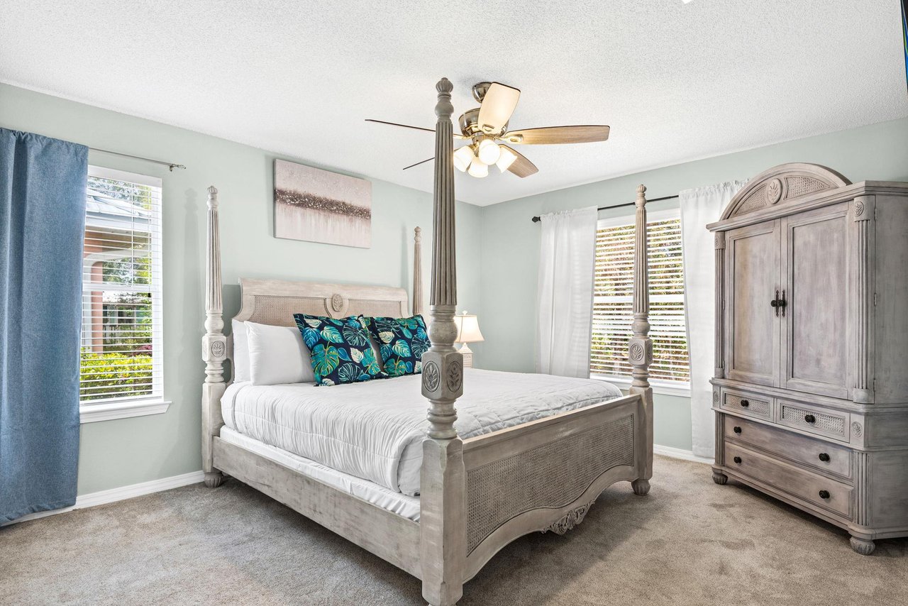 Bedroom 1  Unwind in your elegant fourposter bed beneath a gentle ceiling fan, where coastal blues and crisp linens create the perfect retreat.
