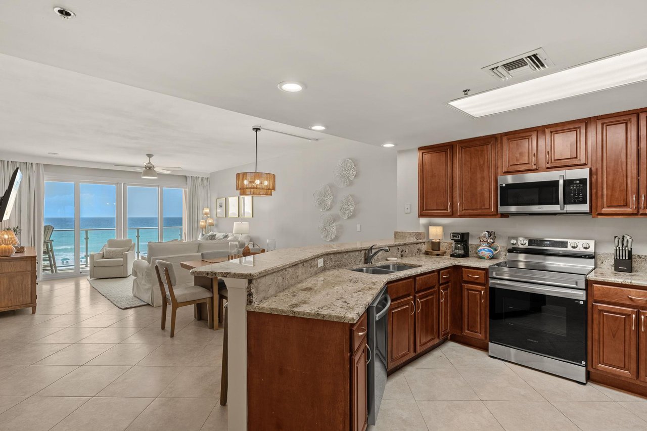 Your fully equipped kitchen flows seamlessly into the living space, with stunning ocean views creating the perfect backdrop for morning coffee.