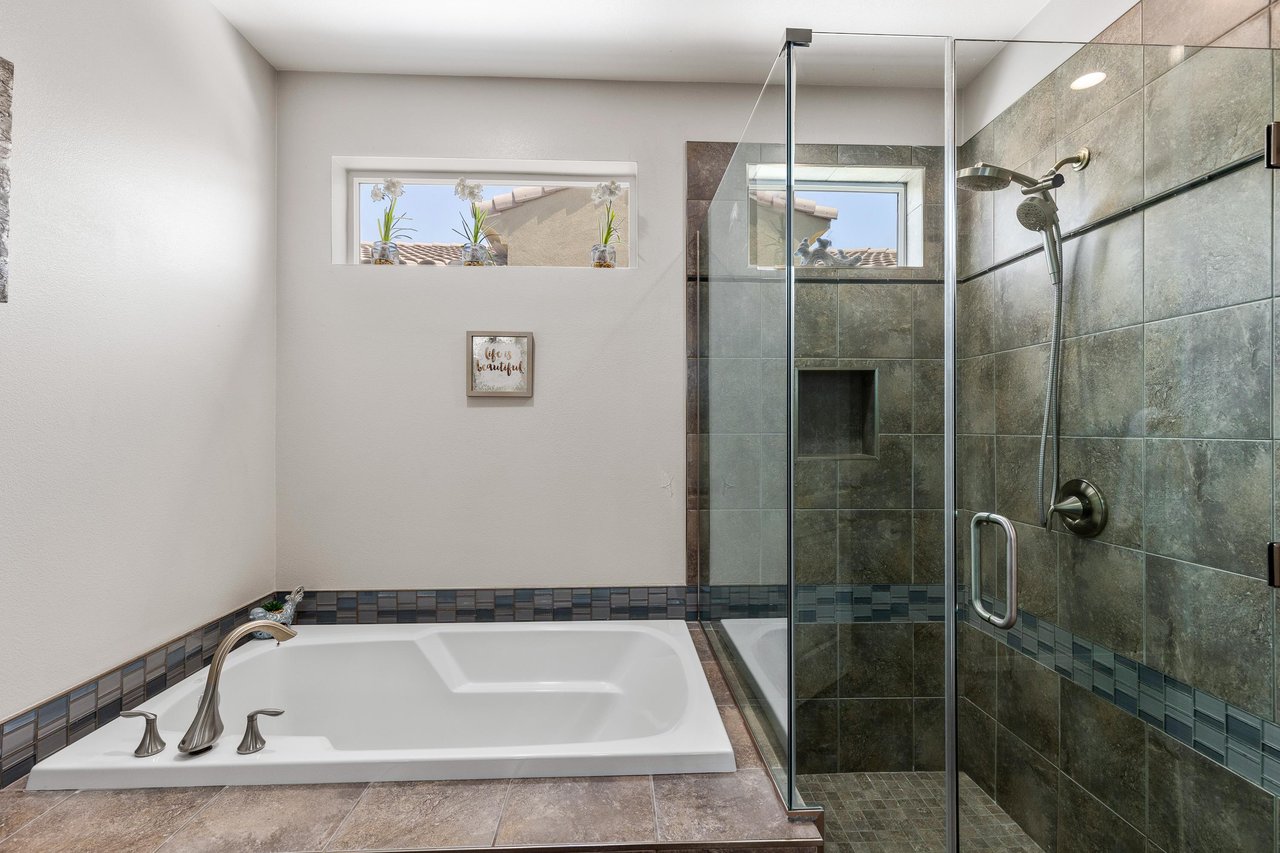 Enjoy a bath or a shower in the primary suite bathroom