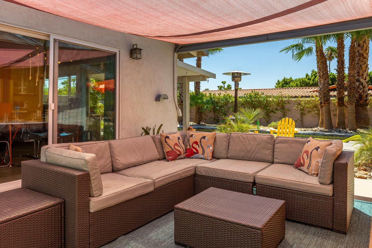 Covered outdoor lounge area with fireplace