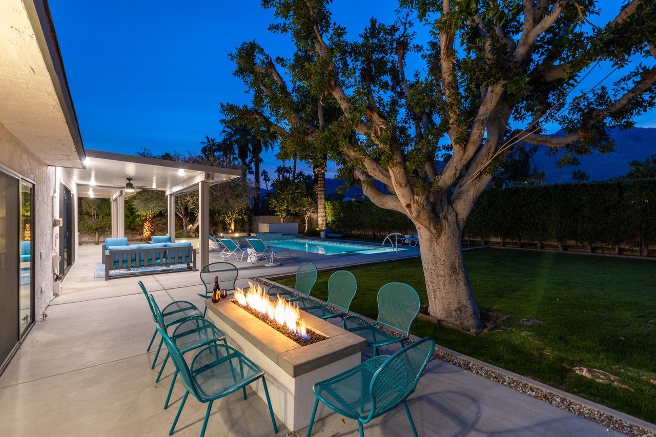 Beautiful landscaping surrounds the fire pit