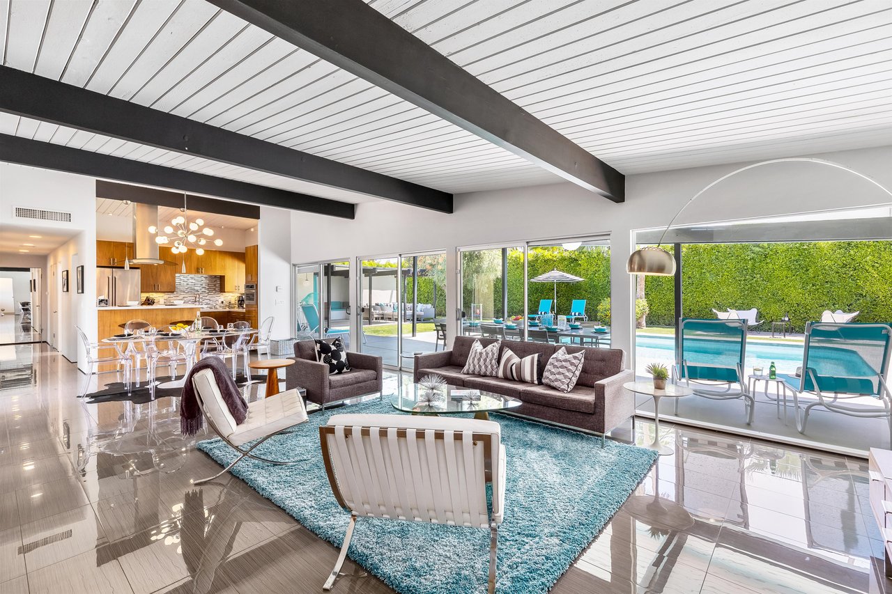 Living room with walltowall backyard views