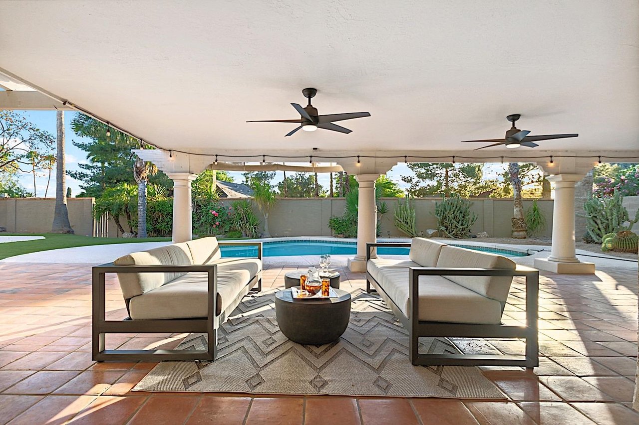 Outdoor sitting area w table and ceiling fans for a nice breeze