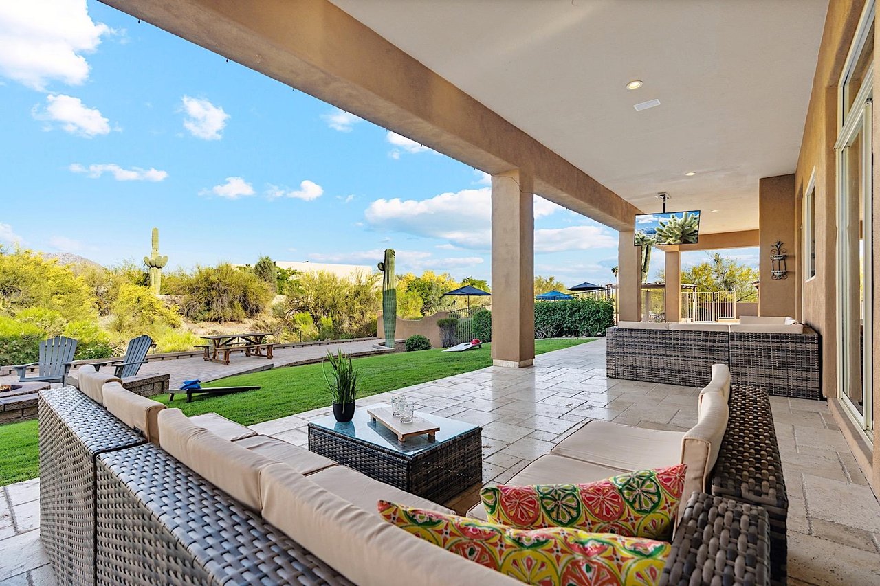 Covered patio during the day. 2 Sofas and a mounted TV