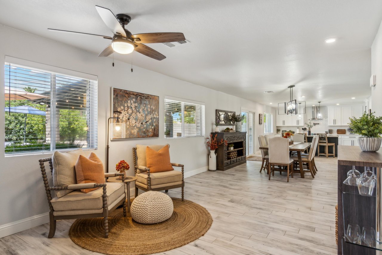 A bright, open living and dining area with a cozy sitting nook.