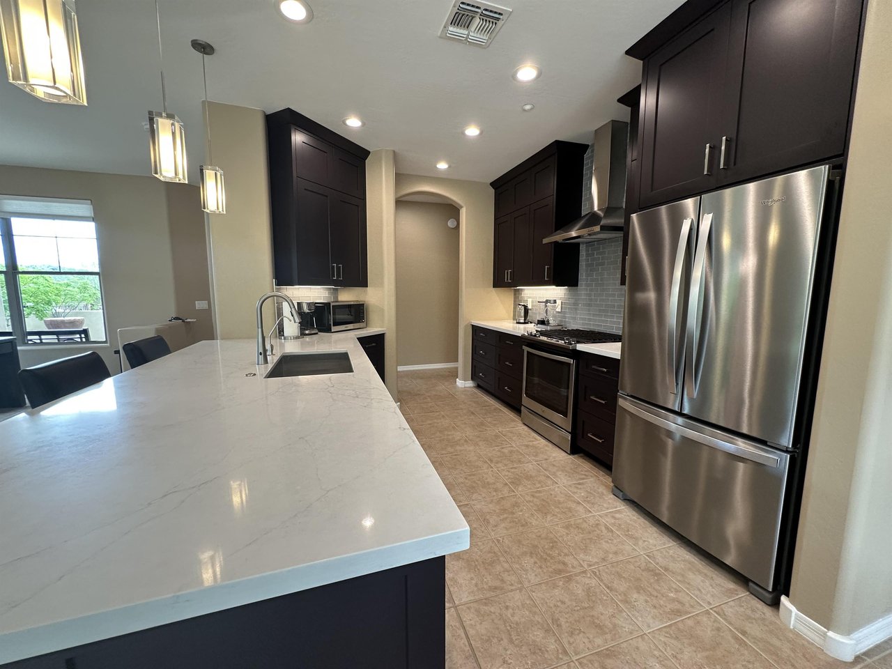 Large fridge with stainless steel appliances.