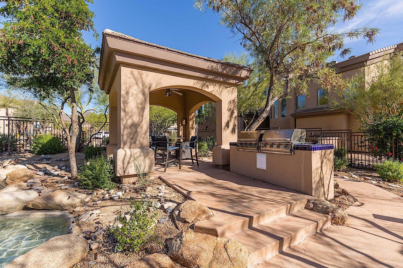 BBQs and covered dining area out by the pool