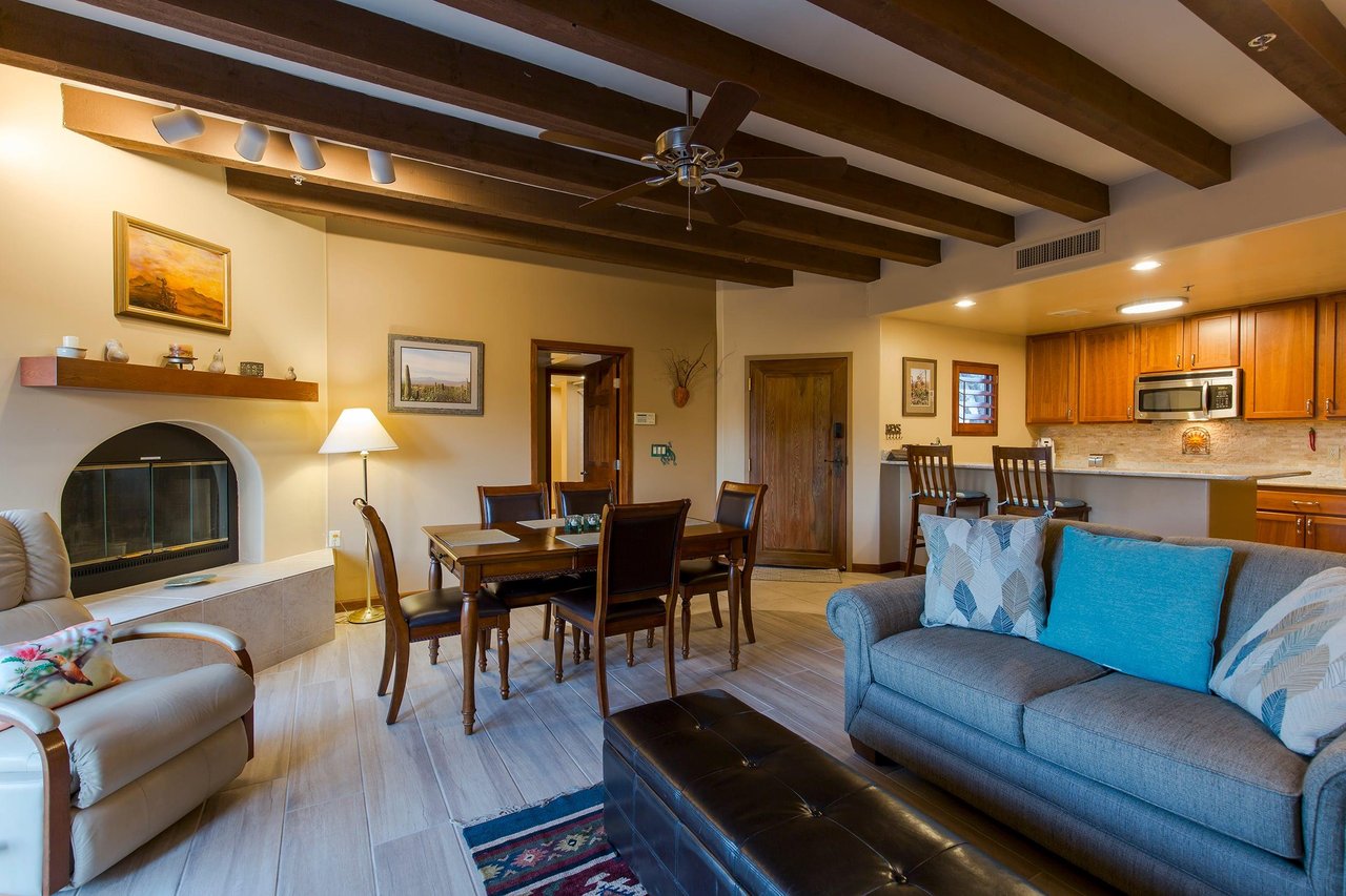 Features a smart TV, woodburning fireplace, and access to the patio.
